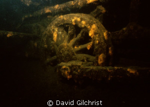 Wide angle close-up of one of the wheels on submerged loc... by David Gilchrist 